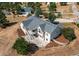 An aerial view captures the home's backyard with its large patio, terraced landscaping and mature trees at 3430 Deer Creek Dr, Parker, CO 80138