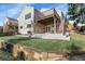 A well-maintained backyard with a patio, wooden deck, stone accents, and lush green grass, creating an inviting outdoor space at 2659 S Halifax St, Aurora, CO 80013