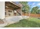 Backyard featuring a concrete patio, wooden deck above, lush grass, and a wooden fence, perfect for outdoor enjoyment at 2659 S Halifax St, Aurora, CO 80013