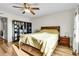 Cozy bedroom features hardwood floors, ceiling fan, and large bookshelf at 2659 S Halifax St, Aurora, CO 80013
