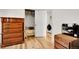 Charming bedroom with a unique wooden dresser and closet visible with doorway to laundry room at 2659 S Halifax St, Aurora, CO 80013