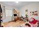 Bedroom with a large harp, window, and hardwood floors at 2659 S Halifax St, Aurora, CO 80013