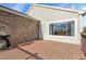 This wooden deck features stone accents, a sliding window, a door and a grill, making it ideal for outdoor cooking and entertaining at 2659 S Halifax St, Aurora, CO 80013