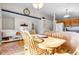 Open dining area with wood table, chairs, kitchen access, and decorative shelving with accent beam at 2659 S Halifax St, Aurora, CO 80013