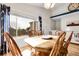 Sunlit dining area with hardwood floors, large window, and cozy table setting at 2659 S Halifax St, Aurora, CO 80013