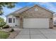 Charming home with stone accents, covered porch, two car garage and well-kept landscaping at 2659 S Halifax St, Aurora, CO 80013
