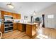 Eat-in kitchen with stainless steel appliances, light countertops, and natural wood cabinets at 2659 S Halifax St, Aurora, CO 80013