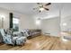 Bright living room featuring hardwood floors, a ceiling fan, and neutral-colored furniture at 2659 S Halifax St, Aurora, CO 80013