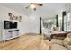 Cozy living room with hardwood floors, a TV on shelving, and comfortable furnishings at 2659 S Halifax St, Aurora, CO 80013