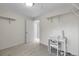 Room with carpet, an open doorway, desk, chair and wall shelves at 2659 S Halifax St, Aurora, CO 80013