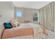 Cozy bedroom with a plush bed, soft pillows, and natural light from the window at 1100 N Marion St # 4, Denver, CO 80218