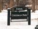 Sign view of Cheesman Park with snow on the ground and bare trees in winter at 1100 N Marion St # 4, Denver, CO 80218