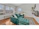 Inviting living room showcasing a stylish velvet sofa, hardwood floors, and natural light streaming through large windows at 1100 N Marion St # 4, Denver, CO 80218