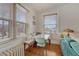 Charming dining nook with bench seating offers a sunlit spot adjacent to a comfortable living area with hardwood floors at 1100 N Marion St # 4, Denver, CO 80218