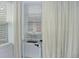 Window view featuring white blinds and curtains, allowing for natural light at 1100 N Marion St # 4, Denver, CO 80218