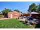 Large backyard with patio, lawn, and detached garage at 1800 S Sherman St, Denver, CO 80210
