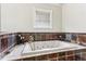 Relaxing bathroom with a large jetted tub and slate tile surround at 1800 S Sherman St, Denver, CO 80210
