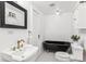 Stylish bathroom with a black clawfoot bathtub and updated fixtures at 1800 S Sherman St, Denver, CO 80210
