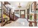 Grand entry with a beautiful staircase and tiled floor at 1800 S Sherman St, Denver, CO 80210