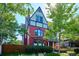Brick home with a charming front porch and mature landscaping at 1800 S Sherman St, Denver, CO 80210