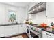Modern kitchen with stainless steel appliances and white cabinetry at 1800 S Sherman St, Denver, CO 80210