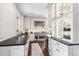 Spacious kitchen featuring white shaker cabinets, dark countertops, and high-end appliances at 1800 S Sherman St, Denver, CO 80210