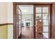 Living room with hardwood floors and fireplace, visible through doorway at 1800 S Sherman St, Denver, CO 80210