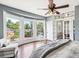 Spacious main bedroom with hardwood floors, bay window, and ceiling fan at 1800 S Sherman St, Denver, CO 80210
