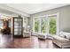 Bright sitting room with hardwood floors, large windows, and comfy seating at 1800 S Sherman St, Denver, CO 80210