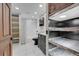 Elegant bathroom featuring black fixtures, a shower-over-tub, open shelving and barn door at 720 16Th St # 421, Denver, CO 80202