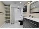 Elegant bathroom featuring black fixtures, a shower-over-tub and open shelving for storage at 720 16Th St # 421, Denver, CO 80202
