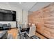 Dining room with modern table, stylish chairs, and industrial-chic wood wall accents at 720 16Th St # 421, Denver, CO 80202
