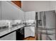 Modern kitchen with white cabinets, granite countertops, stainless steel appliances, and mosaic backsplash at 720 16Th St # 421, Denver, CO 80202