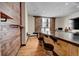 Inviting living area featuring exposed brick and rustic barn door window accents with bar stool seating at 720 16Th St # 421, Denver, CO 80202