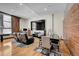 Modern living and dining area featuring hardwood floors and industrial chic accents and modern black leather reclining sofa at 720 16Th St # 421, Denver, CO 80202