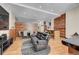 Open-concept living space featuring exposed wood accents, stylish decor, and a comfortable black leather sofa at 720 16Th St # 421, Denver, CO 80202