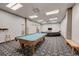 Enjoy building amenities, like this comfortable recreation room with a pool table and TV at 720 16Th St # 421, Denver, CO 80202