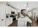 Updated kitchen featuring a large island, stainless steel appliances, and views of the staircase at 7579 S Zante Ct, Aurora, CO 80016