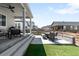 Spacious backyard featuring a patio with outdoor dining, seating, and lush artificial grass, perfect for entertaining at 777 Gold Hill Dr, Erie, CO 80516