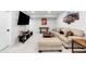 A finished basement featuring a comfortable seating area, foosball table, and sports memorabilia at 777 Gold Hill Dr, Erie, CO 80516