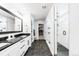 Sleek bathroom with double vanity, walk-in shower, and modern fixtures at 777 Gold Hill Dr, Erie, CO 80516