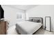 A simply decorated bedroom with a gray bed and bedding, a desk, and a window at 777 Gold Hill Dr, Erie, CO 80516