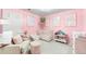 Charming pink Bedroom with a crib, comfortable seating, and decorative floral accents at 777 Gold Hill Dr, Erie, CO 80516