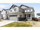 Charming two-story home with a well-maintained lawn, stone accents, and a two-car garage at 777 Gold Hill Dr, Erie, CO 80516