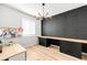 Modern home office with a built-in desk, dark accent wall, and contemporary lighting at 777 Gold Hill Dr, Erie, CO 80516