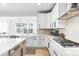 Bright kitchen with white cabinets, stainless steel appliances, and hardwood floors at 777 Gold Hill Dr, Erie, CO 80516