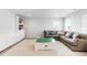 Comfortable living room with a large sectional sofa, built-in storage, and a play table at 777 Gold Hill Dr, Erie, CO 80516