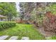 Private backyard with lush lawn, mature trees, and a charming wooden fence for serene outdoor enjoyment at 2 Elm St, Denver, CO 80220