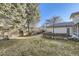 Large backyard with grassy area, mature trees and privacy fence at 2 Elm St, Denver, CO 80220