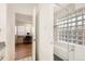 Spa-like bathroom with a glass block shower, hardwood floors, and an office just beyond the doorway at 2 Elm St, Denver, CO 80220